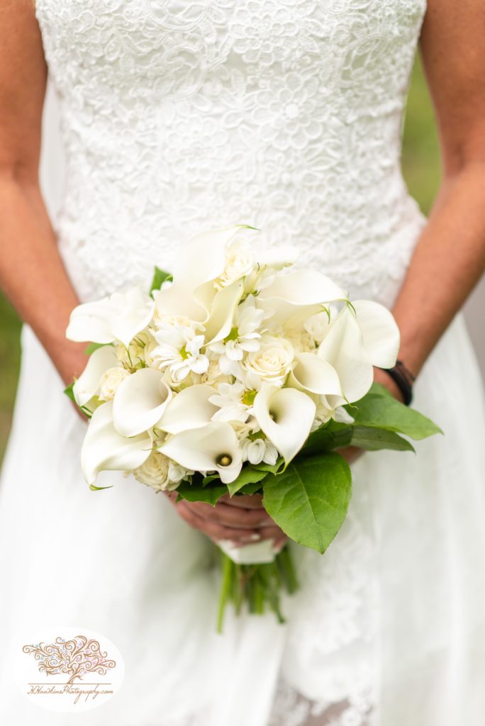 Bride holds a bouquet of Calla Lillies on her wedding day captured by Fingerlakes Wedding photographer