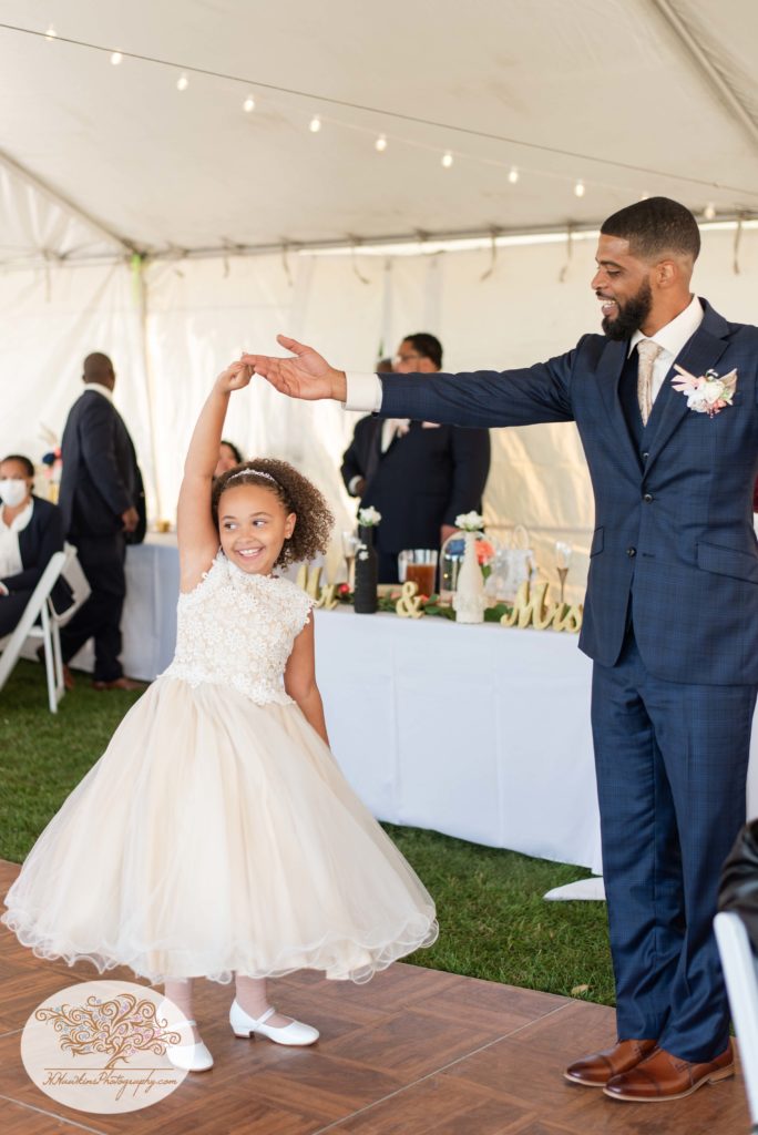Groom dances with flower girl on his wedding day at Bride and groom come down the aisle after they're married at the Glen Doone Pavilion at John Boyd Thatcher State Park