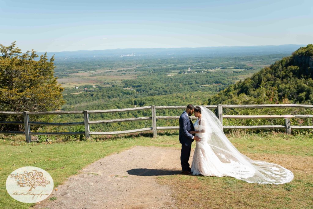 Bride and groom stand in front of gorgeous overlook at the John Boyd Thatcher State Park in Albany NY