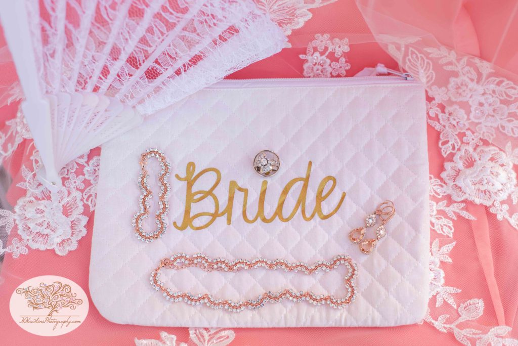 Bride bag with diamond wedding rings, necklace, bracelet and earrings
