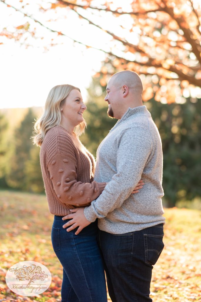 Newly engaged couple laugh together right after he surprised her with a proposal at Gillie Lake in Camillus NY by Syracuse engagement photographer