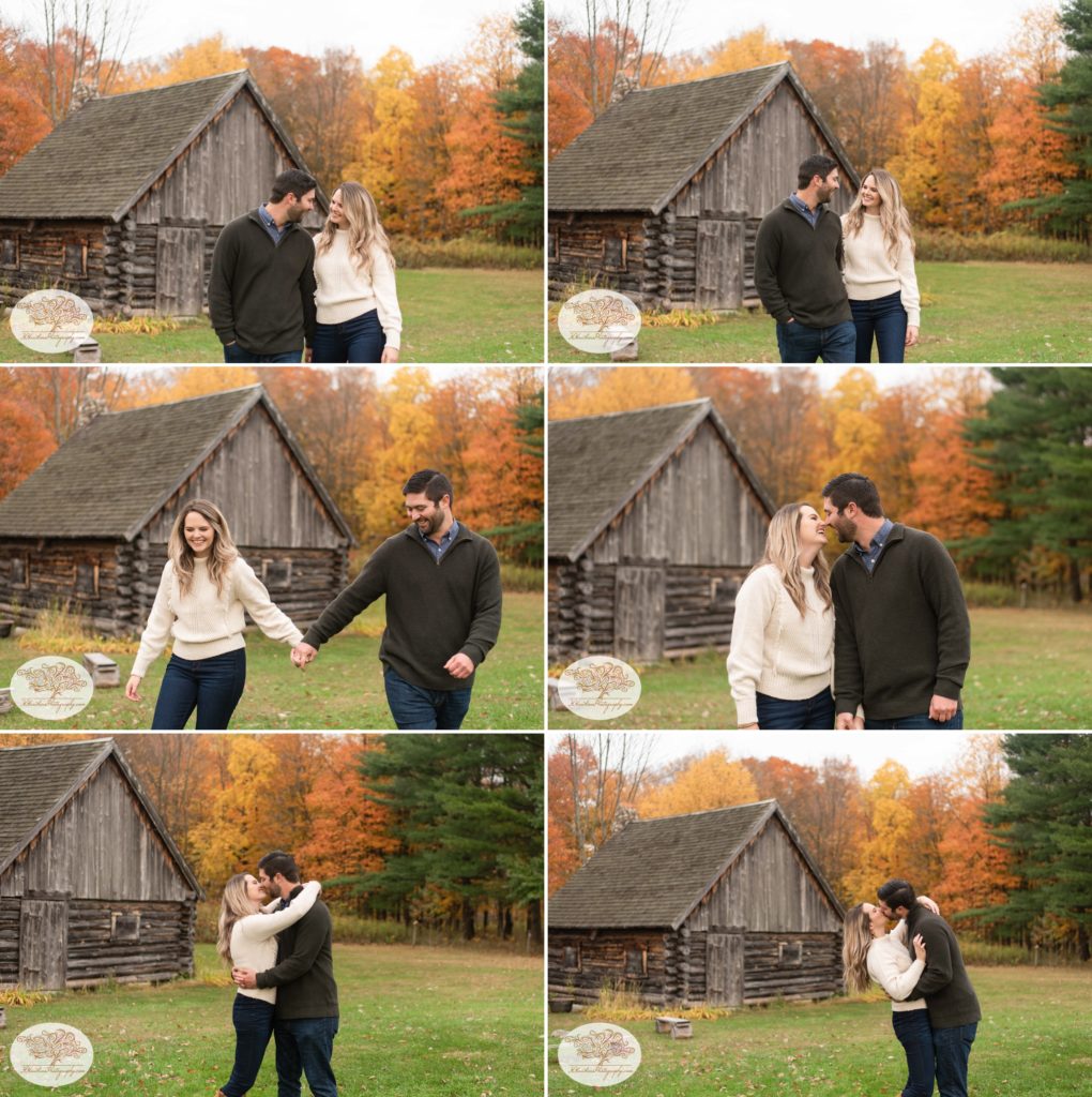 Engaged couple walk together holding hands in front of log cabin at Baltimore Woods in Marcellus NY for their Syracuse fall engagement pictures