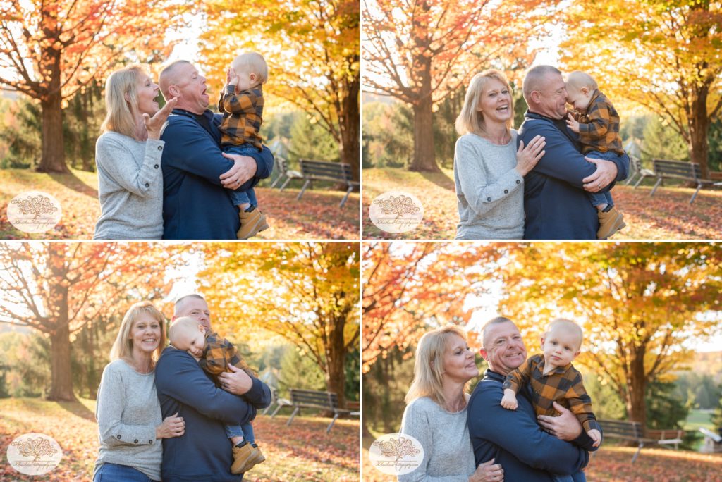 Grandparents hold their grandson and play peek a boo with Syracuse family photographer capturing the pictures