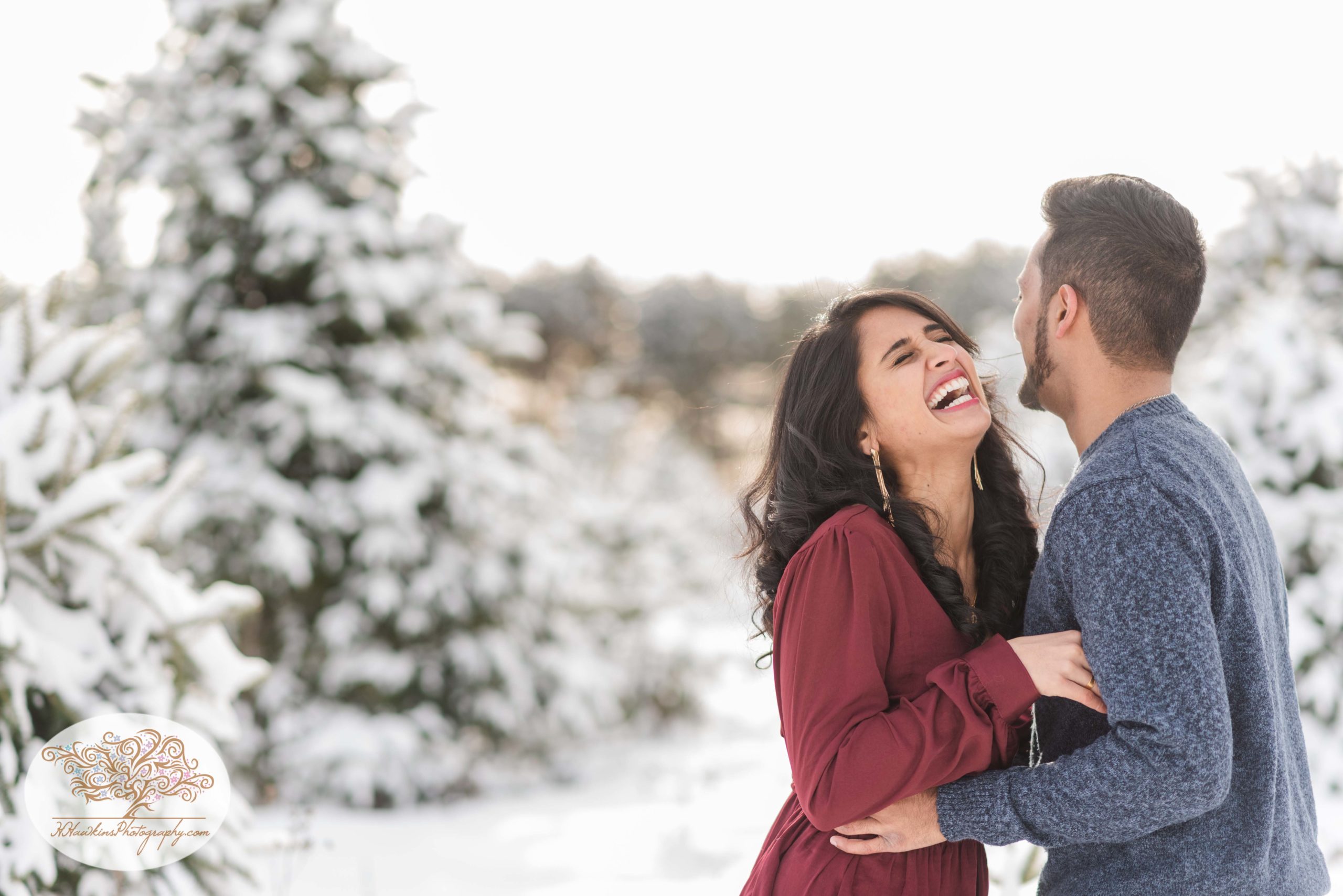Engaged couple gets their photos taken at a Christmas tree farm in the snow at Critz in Cazenovia NY