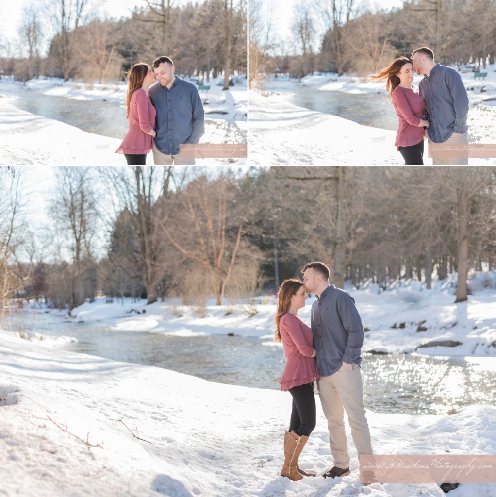Bride and groom stand in front of a snowy river in Marcellus Park NY for their engagement pictures