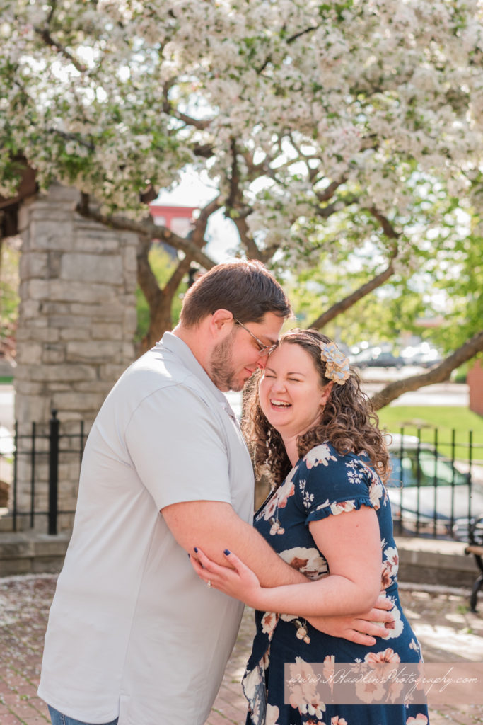 Groom makes bride laugh during engagement photos at Franklin Square Park in Syracuse NY