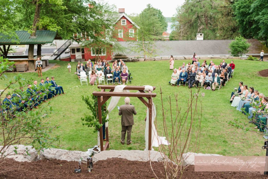 Wedding ceremony held at the Springside Inn Auburn NY in the back lawn with bridal party surrounding them