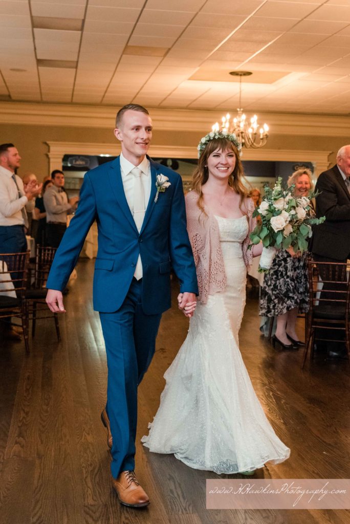 Bride and groom enter their wedding reception at the Springside Inn in Auburn NY with smiles on their faces