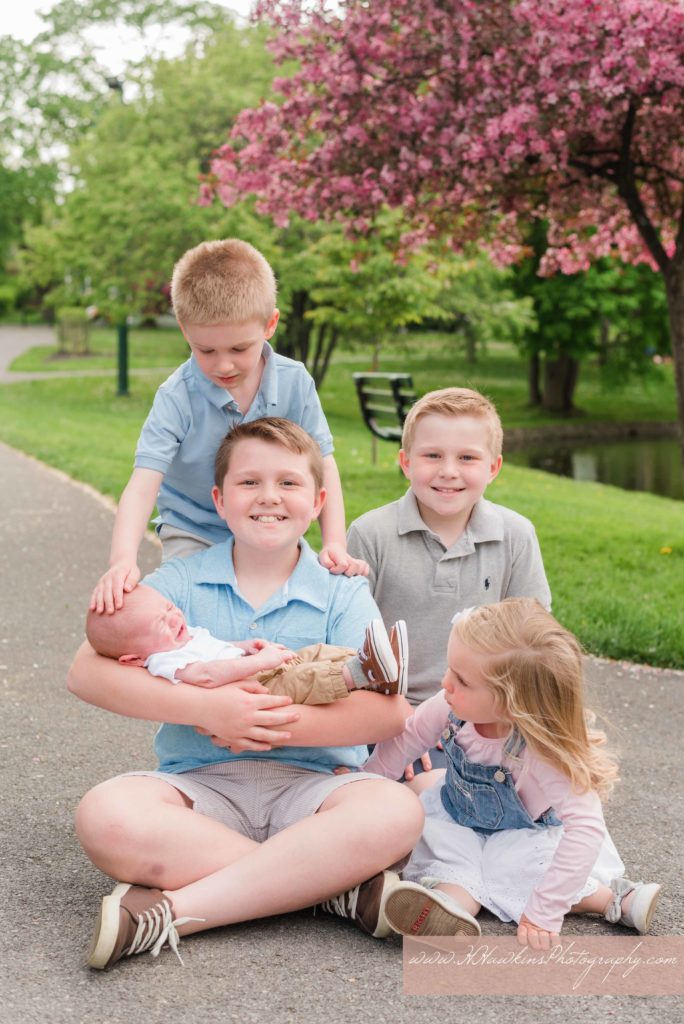 cousins together during extended family portrait session by Syracuse photographer with baby
