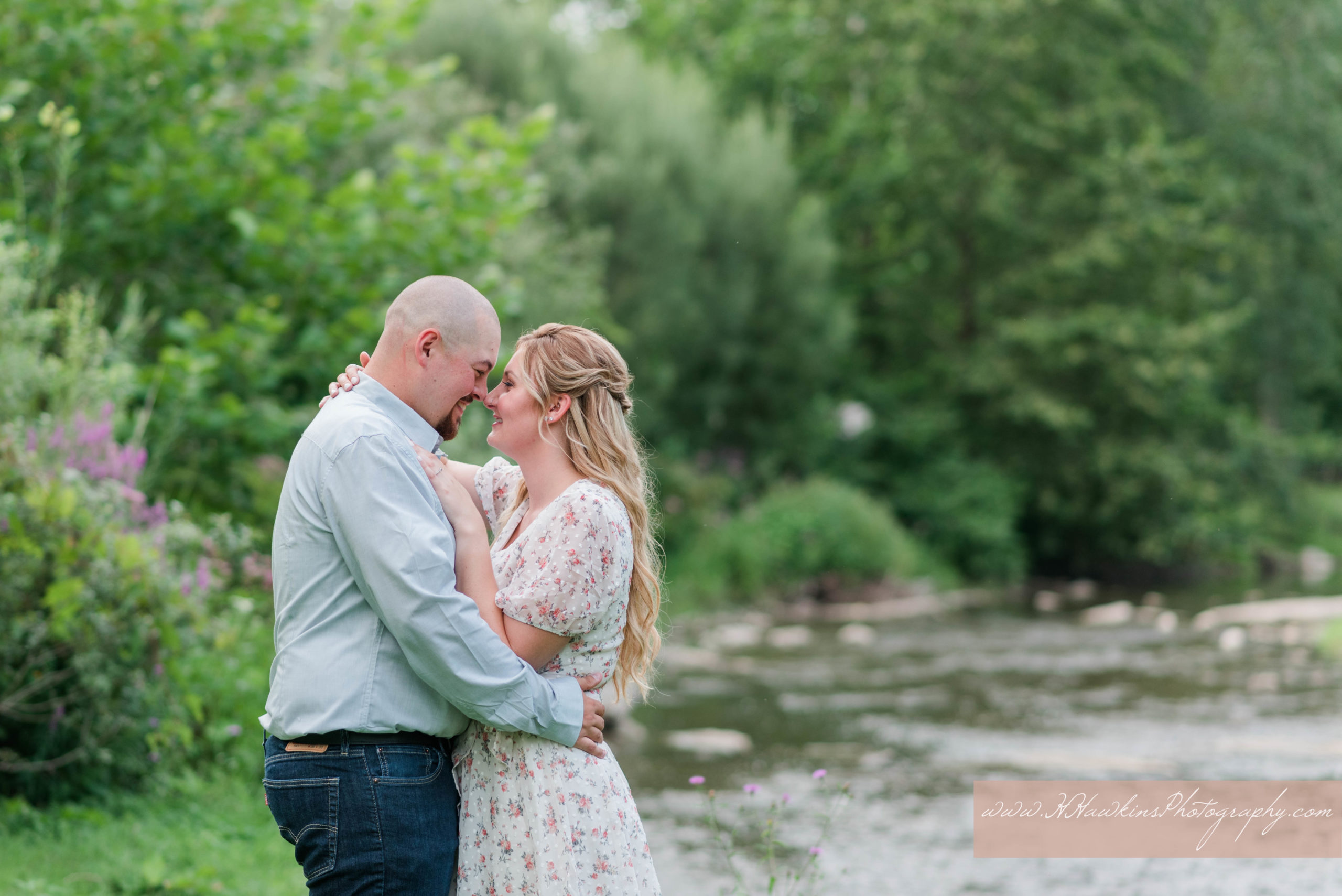 engagement pictures taken by camillus photographer at the stream at Marcellus Park for groom kissing bride