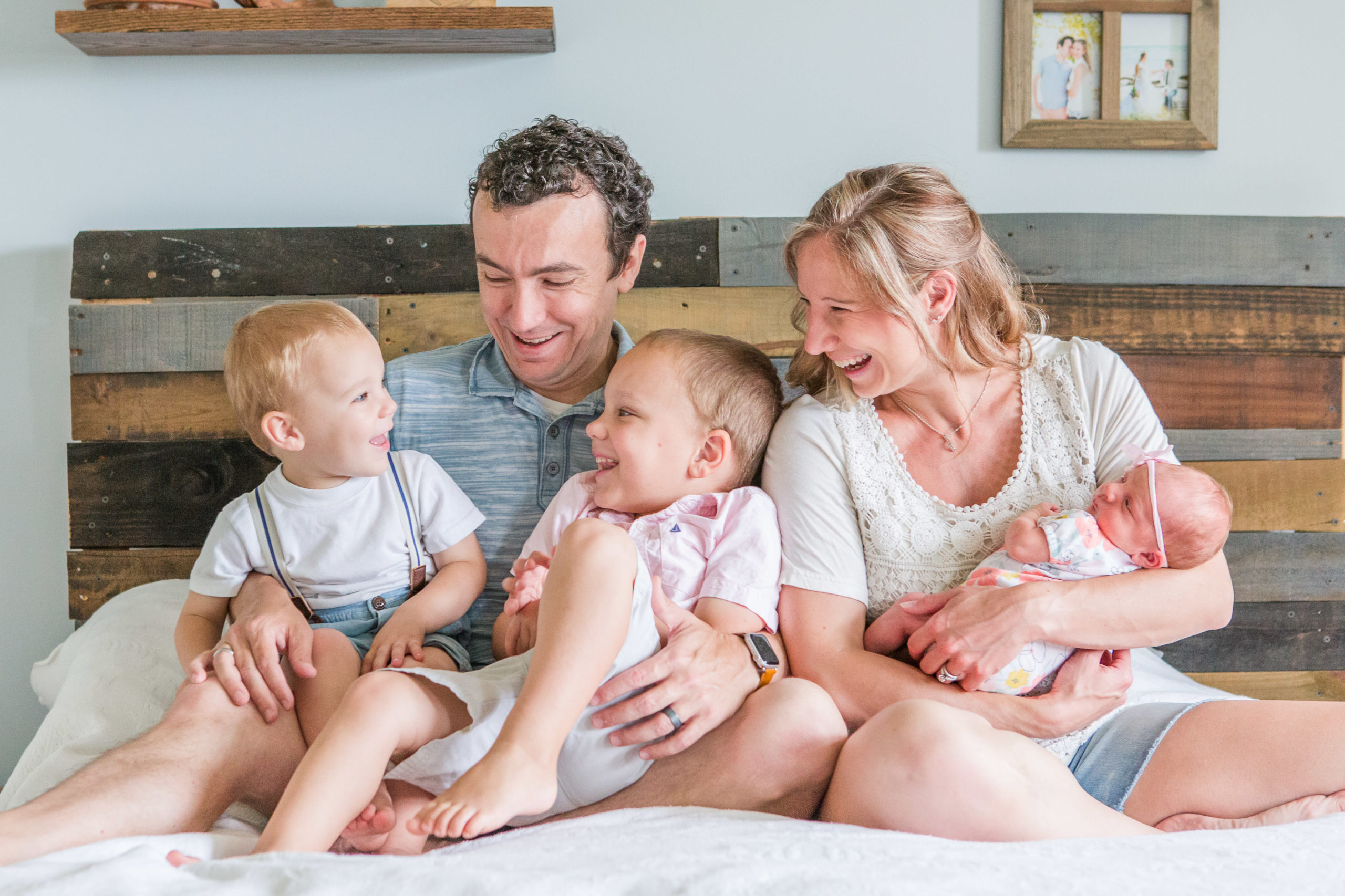 Team Hawkins of H Hawkins Photography with their three kids during newborn family session