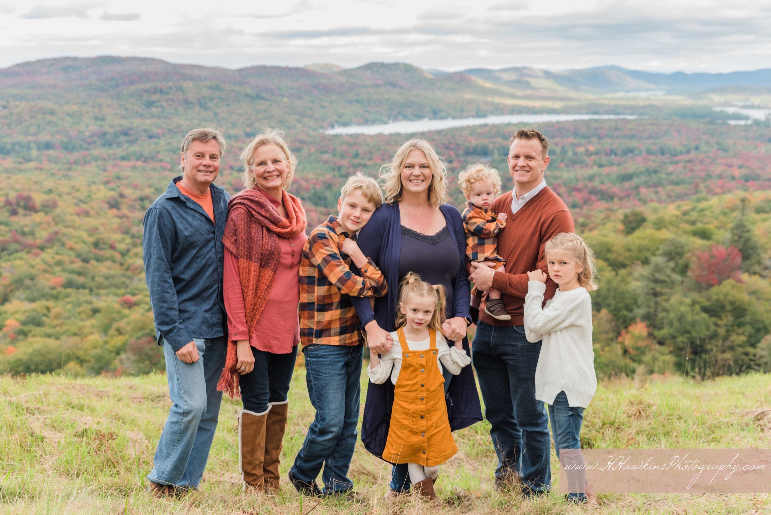 Photos of a family at the top of McCauley mountain with First Lake in the background in Old Forge NY Adirondacks