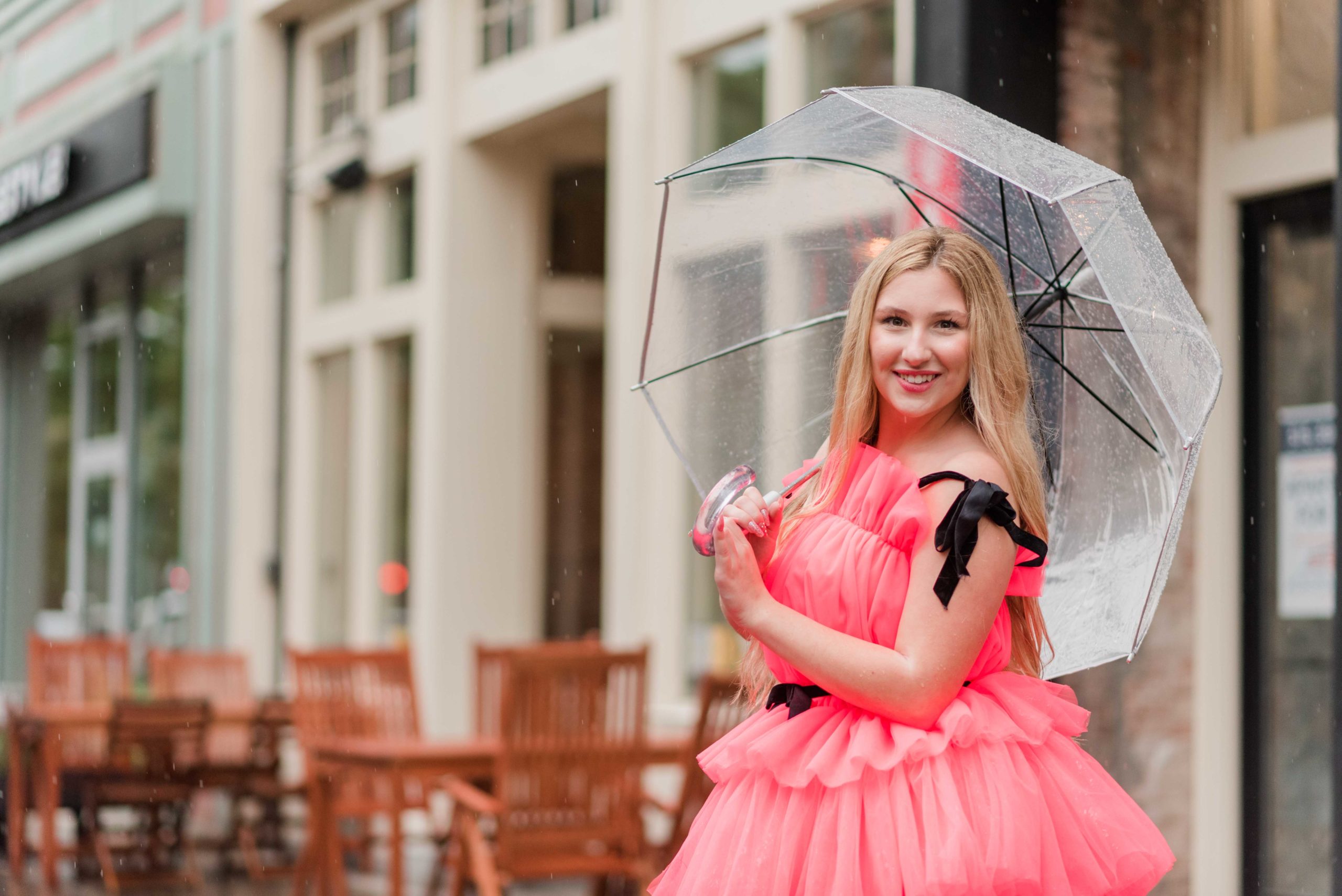 Syracuse senior portraits of girl in pink dress and umbrella in downtown Syracuse