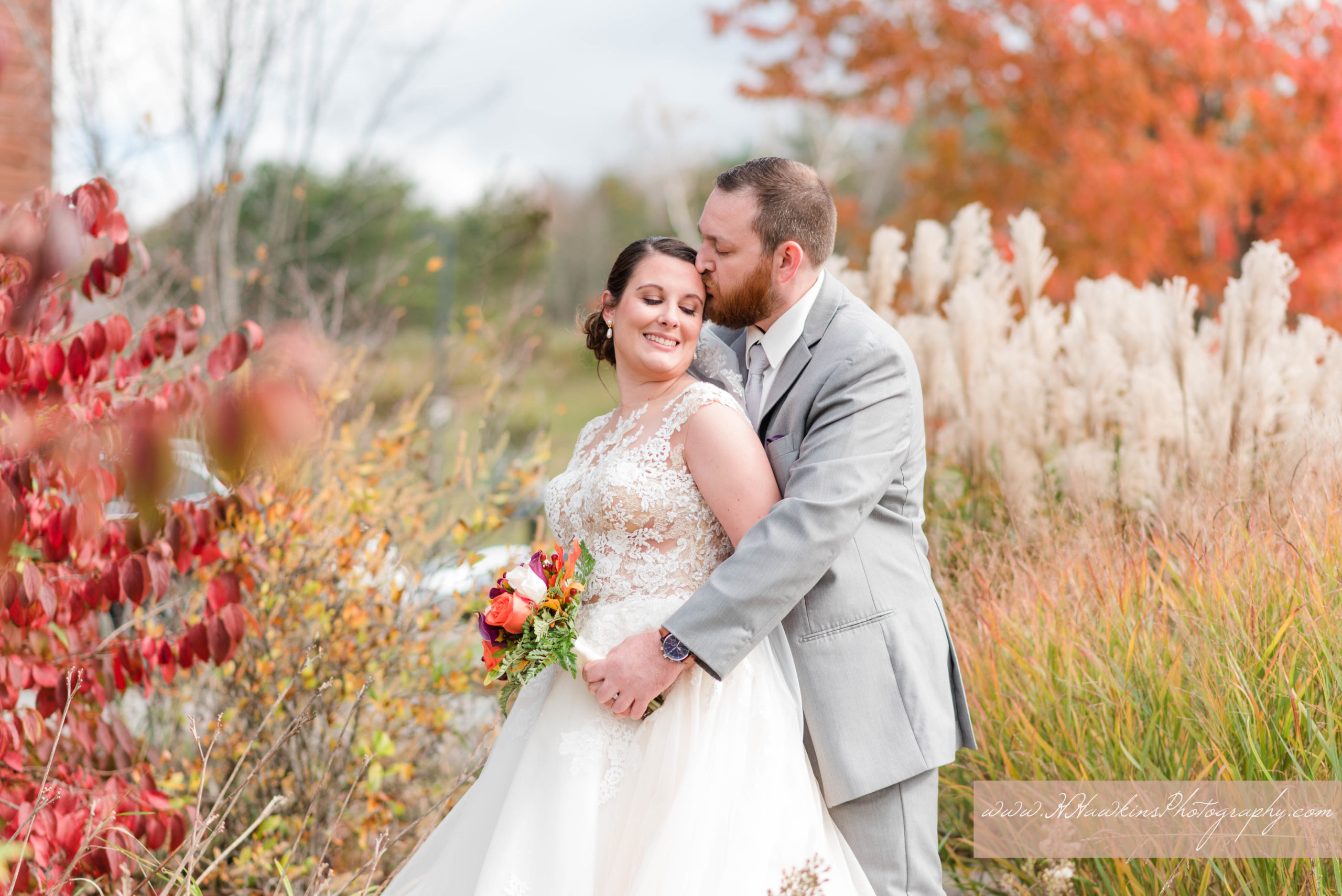 Portraits of bride and groom with autumn colors on their wedding day at Greek Peak's Hope Lake Lodge by Syracuse photographer