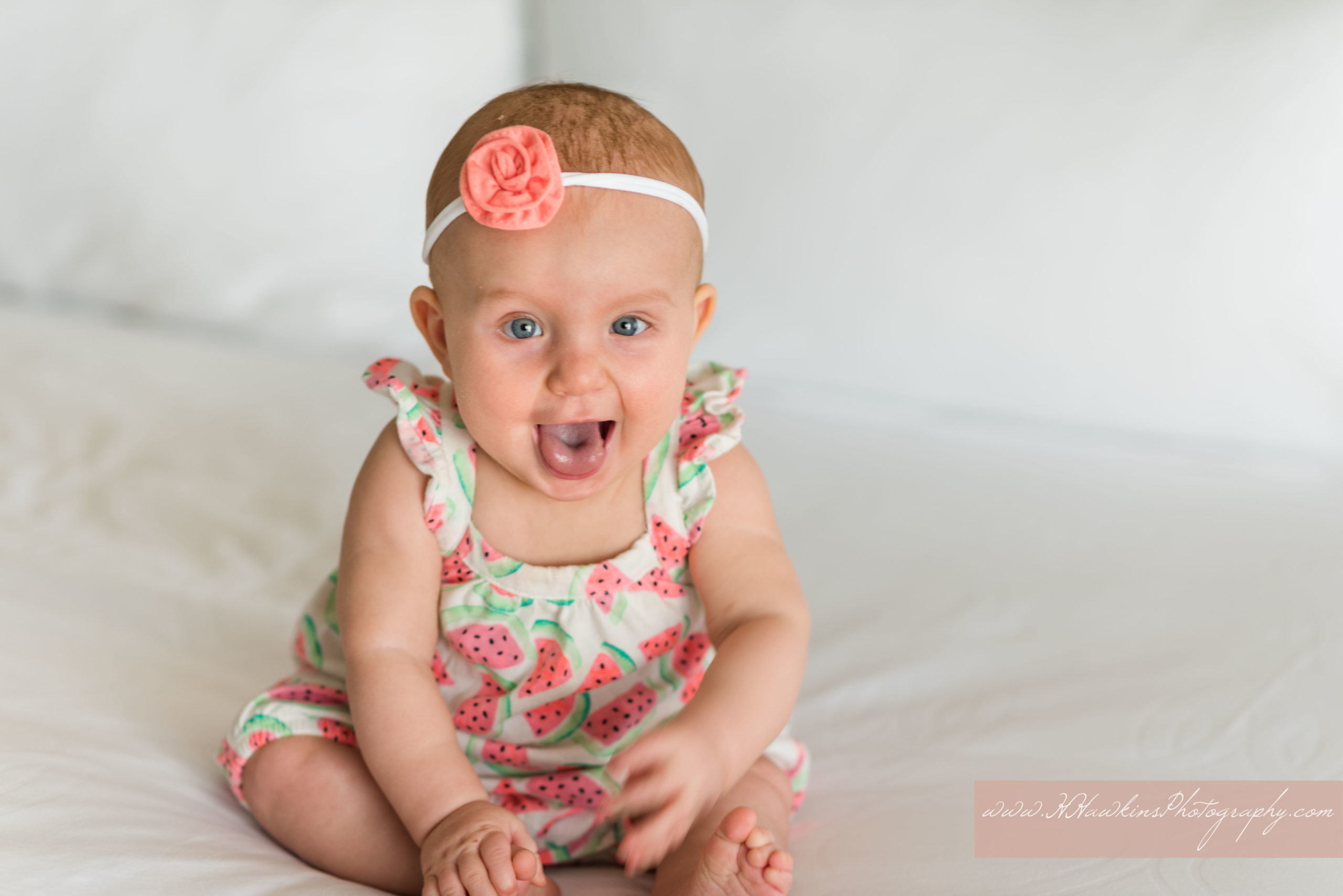 Picture of baby girl in watermelon outfit on vacation by Orlando photographer at Westgate Lakes in Florida