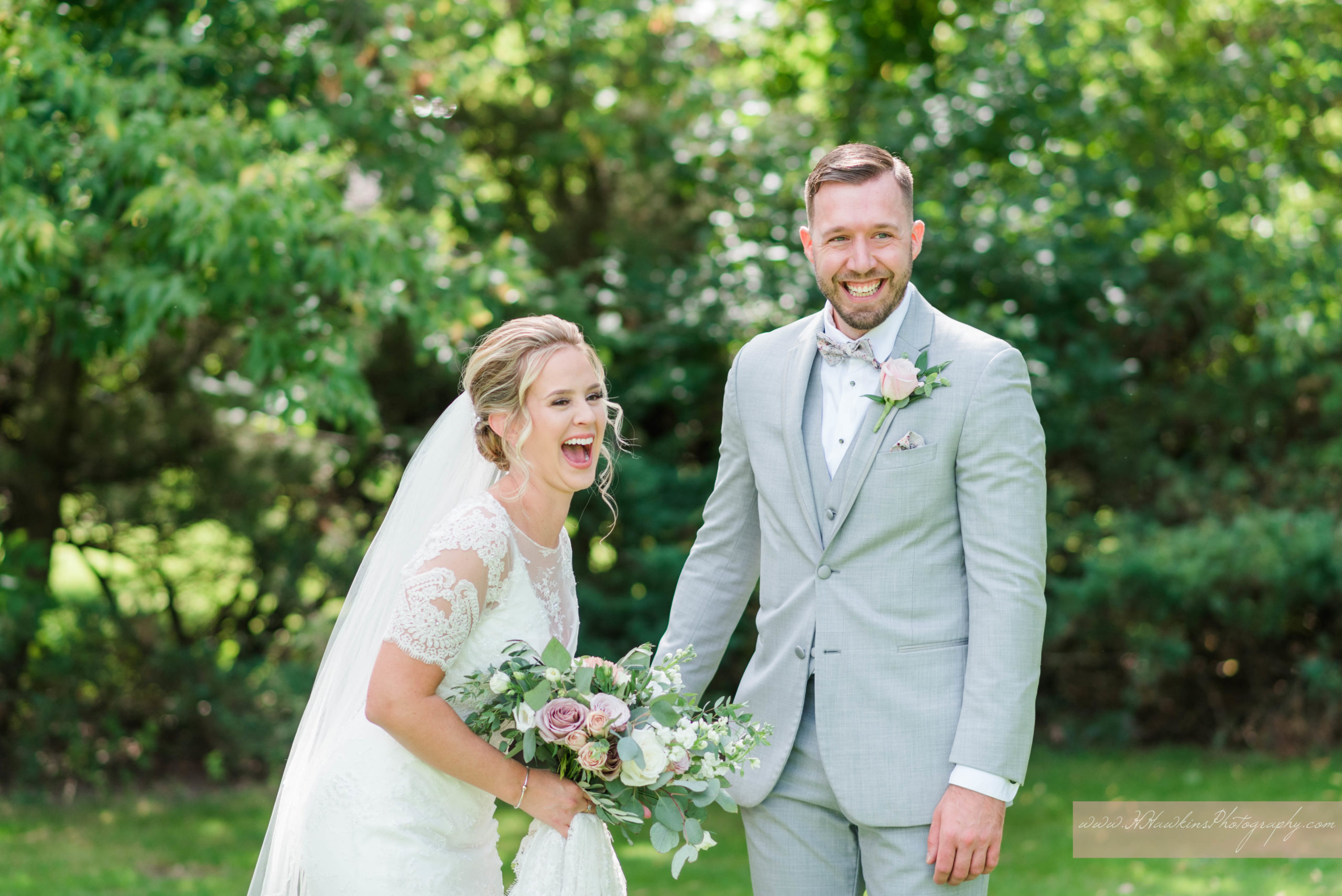 First look of bride in Olia Zavozina wedding dress and groom in grey tux at their castle wedding venue