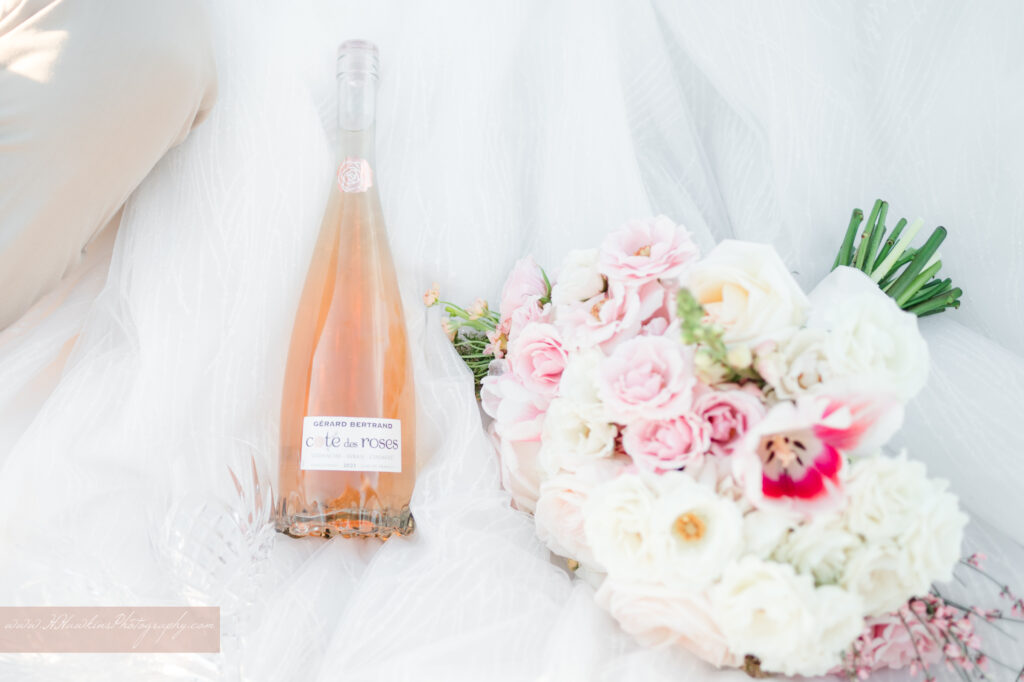Pink and white bridal bouquet with rose wine at acres of grace