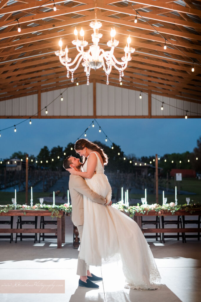 Groom spins bride at Acres of Grace wedding venue barn in Howey in the Hills FL