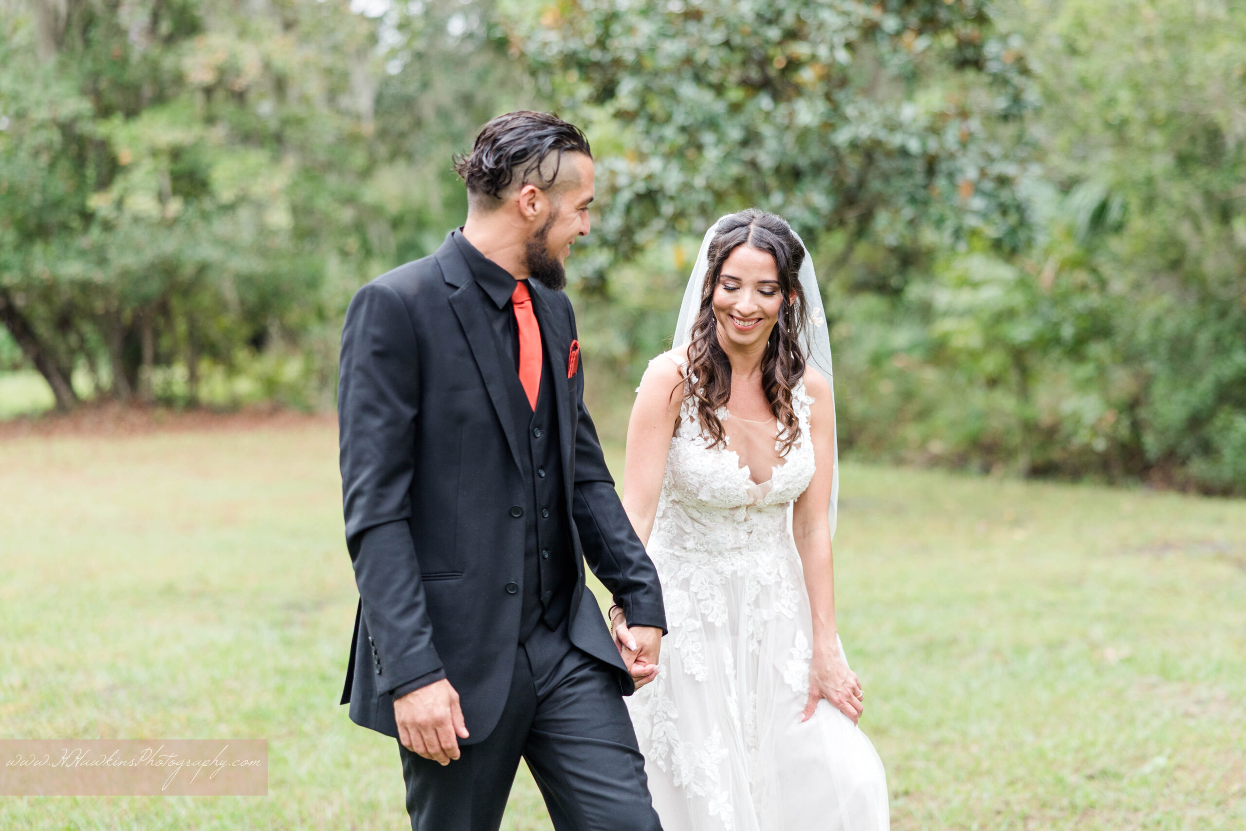 Central Florida Wedding photographer captures bride and groom walking hand in hand at Danville B&B in Geneva FL