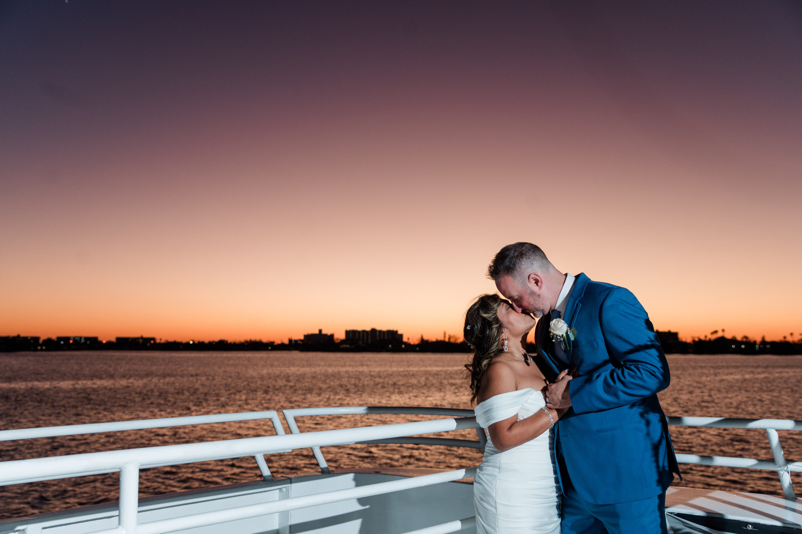 Bride and groom kiss on board the Sapphire Yacht by Starlite Cruises out of St. Pete FL by St. Pete wedding photographer