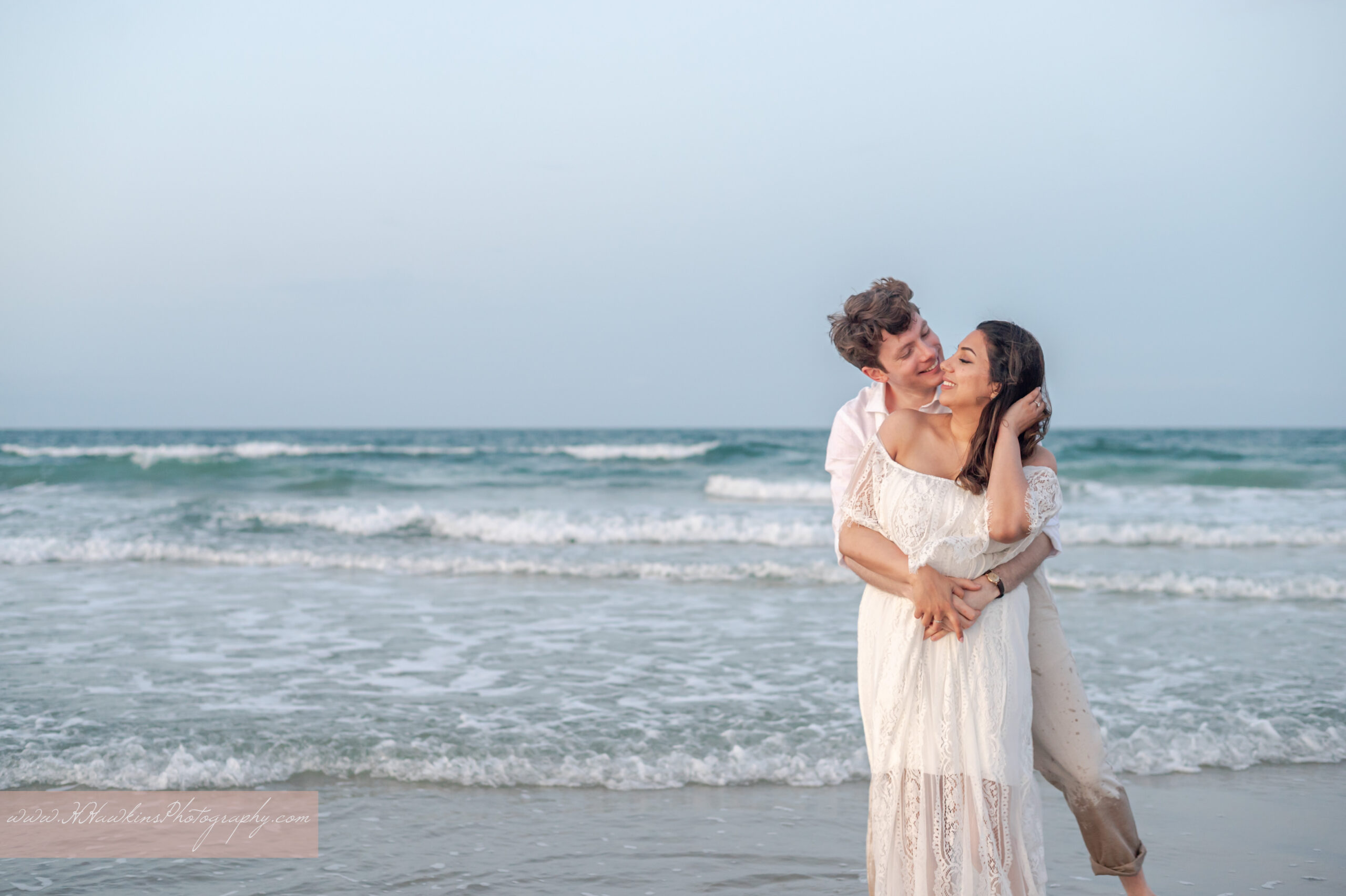 The playfulness and laughter by bride and groom on the beach at sunset after their Ponce Inlet elopement photos